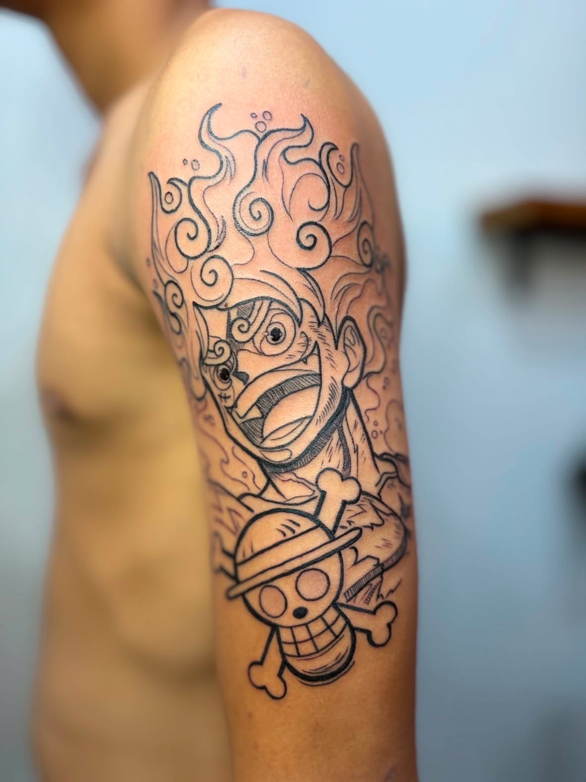 Anime line-work sleeve tattoo