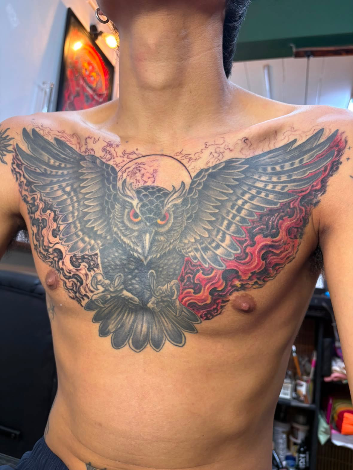 Large owl chest tattoo with flames