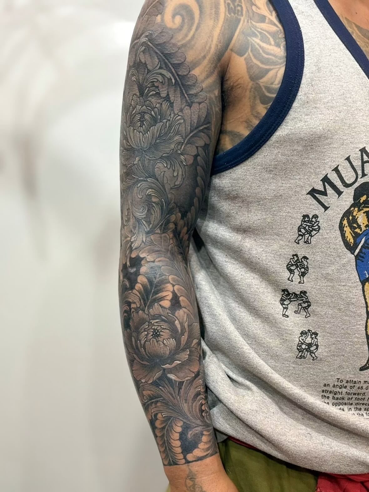 Ornamental floral sleeve tattoo