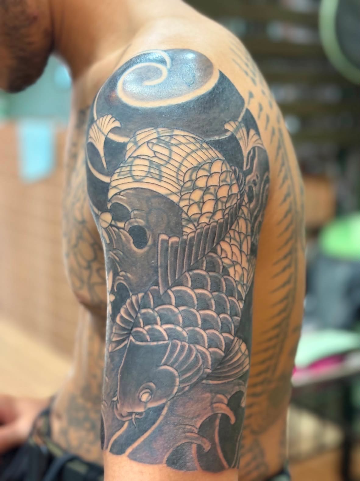 Black and grey koi shoulder tattoo