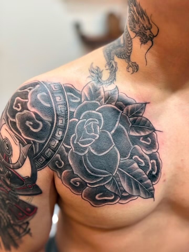 Bold rose chest tattoo