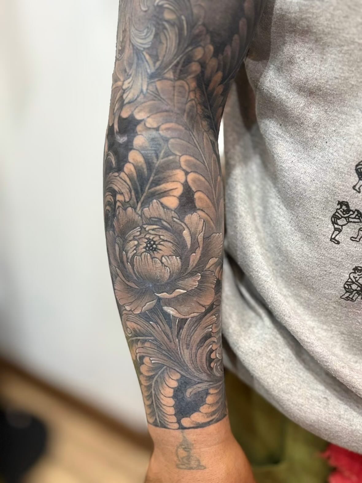 Black and grey peony sleeve tattoo